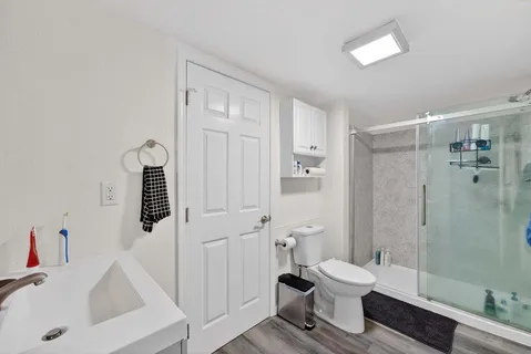 a bathroom with a toilet sink and mirror