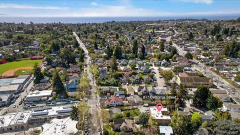 an aerial view of a residential apartment building and trees
