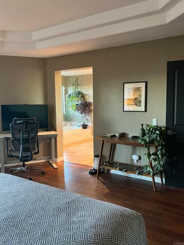 a living room with furniture a window and a flat screen tv