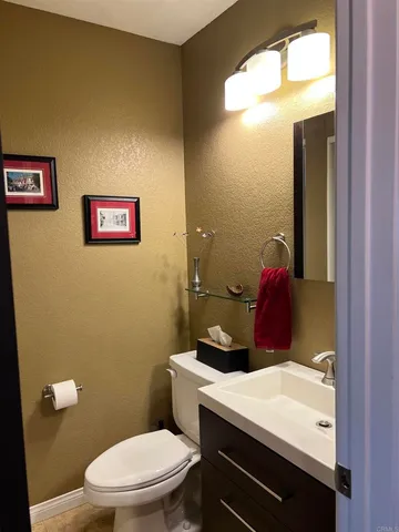 a bathroom with a toilet a sink and mirror
