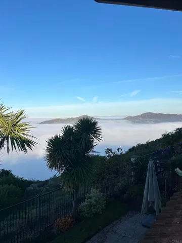 a view of a balcony with a yard