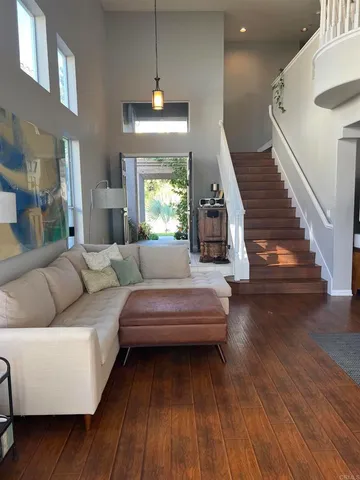 a living room with furniture and a wooden floor