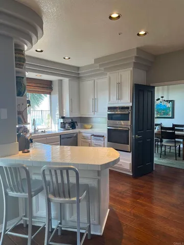 a large kitchen with kitchen island a large counter space and stainless steel appliances