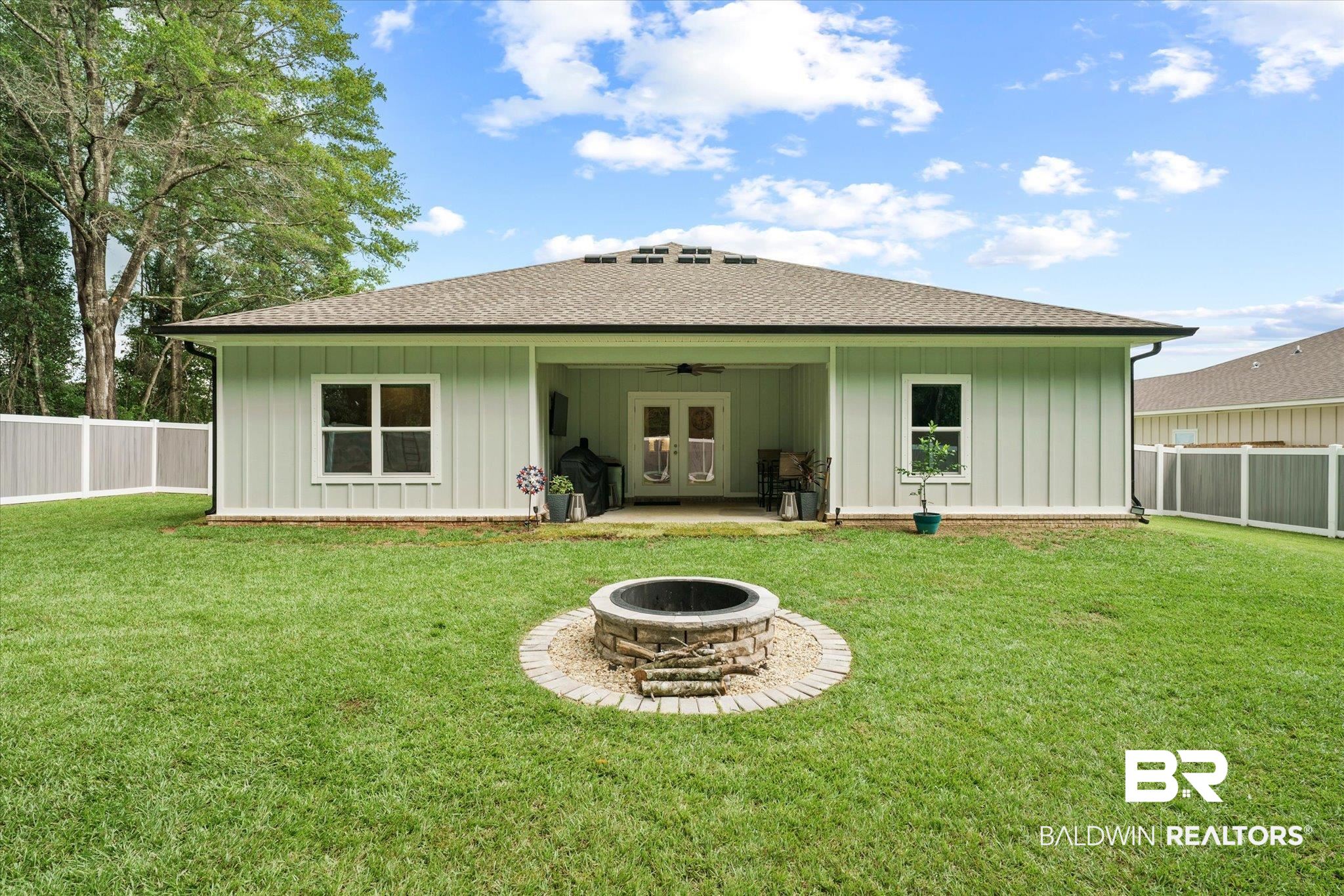 263 Bronze Street Fairhope, AL 36532 - Photo 29 of 47 Rear view of house with a yard, ceiling fan, a patio, and an outdoor fire pit