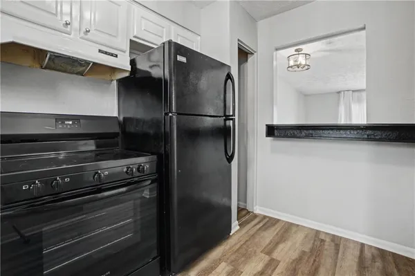 a metallic refrigerator freezer sitting in a kitchen