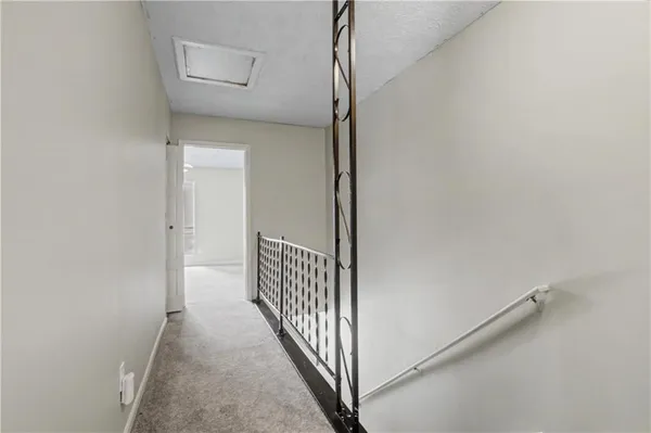 a view of a hallway with wooden floor and entryway