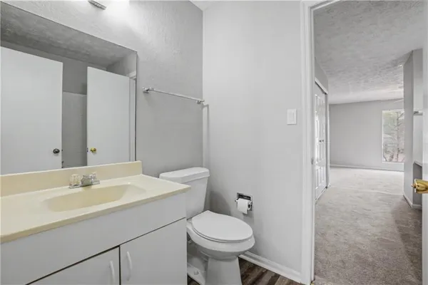 a bathroom with a sink toilet and a mirror