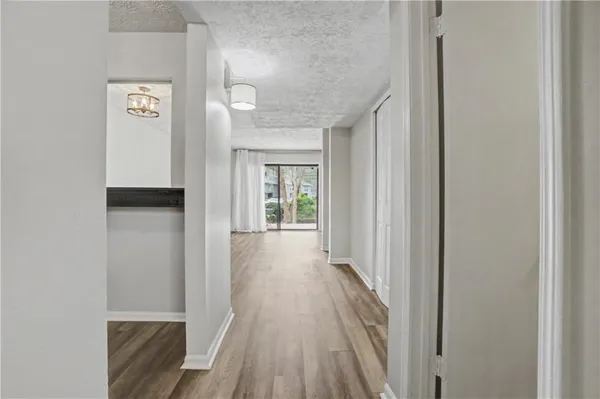 a view of a hallway with wooden floor