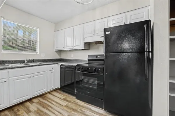 a kitchen with a refrigerator and a sink