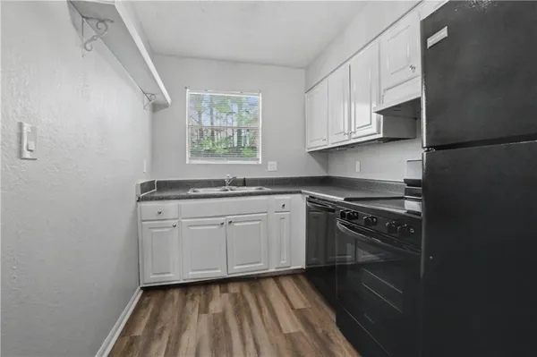 a kitchen with a sink stove and cabinets
