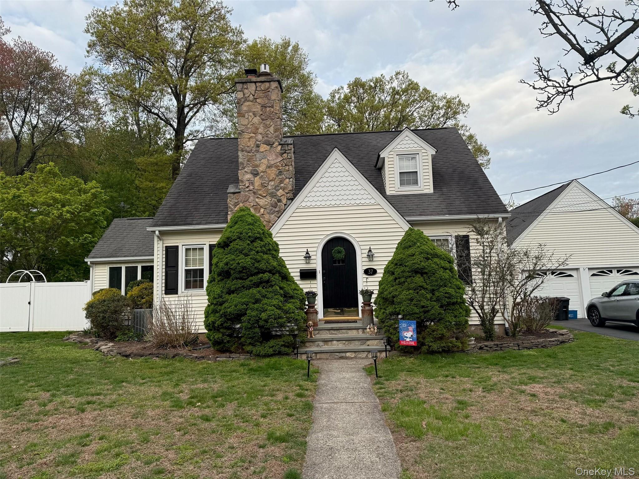 a front view of a house with a garden