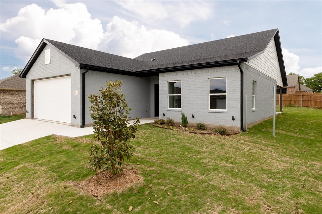 912 Avagail Avenue Springtown, TX 76082 - Photo 1 of 1 a house that has a tree in front of it