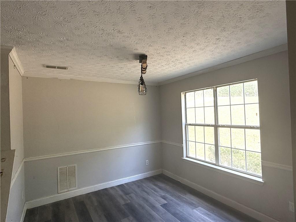7251 Williams Road Flowery Branch, GA 30542 - Photo 2 of 10 an empty room with wooden floor and windows