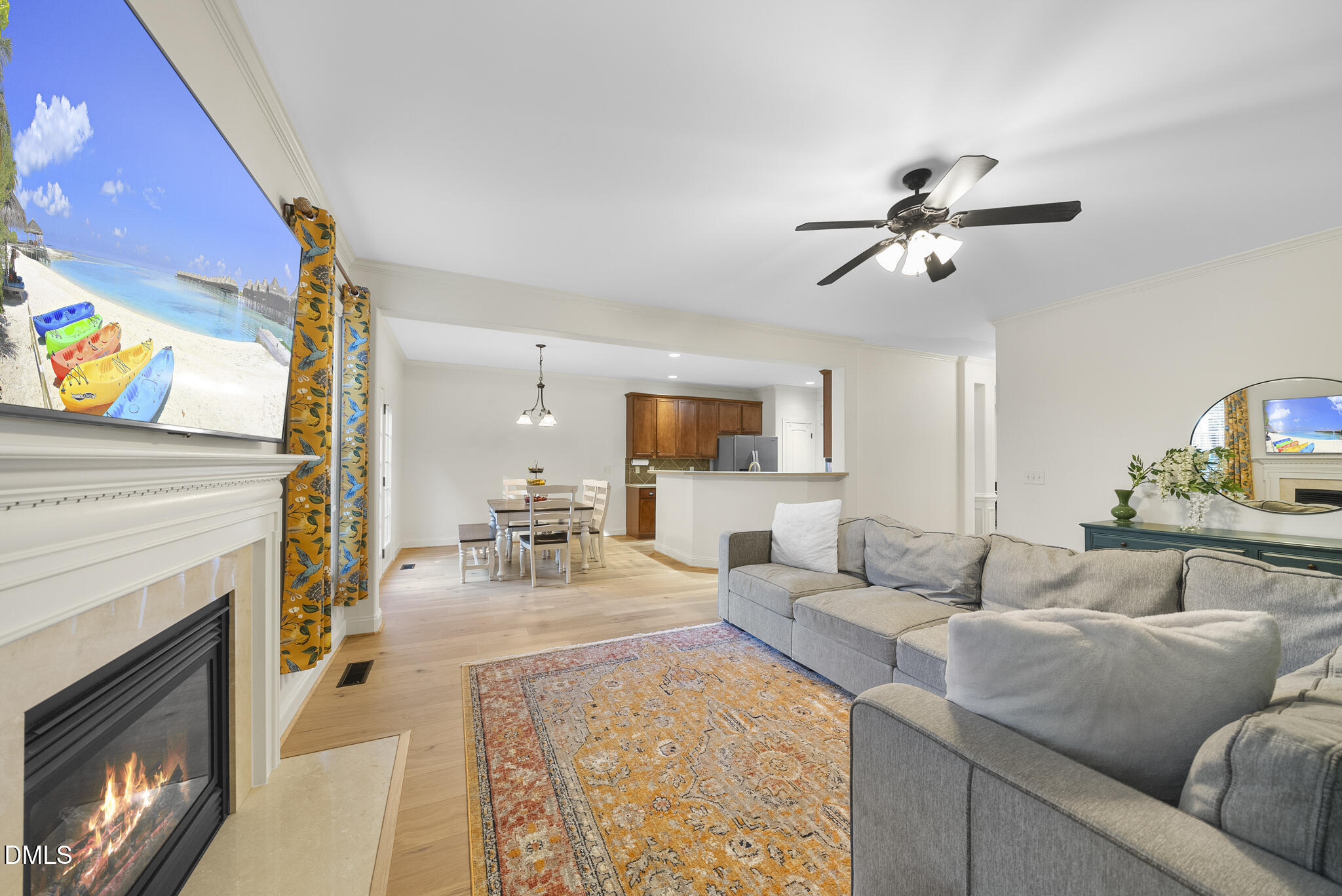 437 Big Willow Way Rolesville, NC 27571 - Photo 12 of 43 a living room with furniture a fireplace and a flat screen tv
