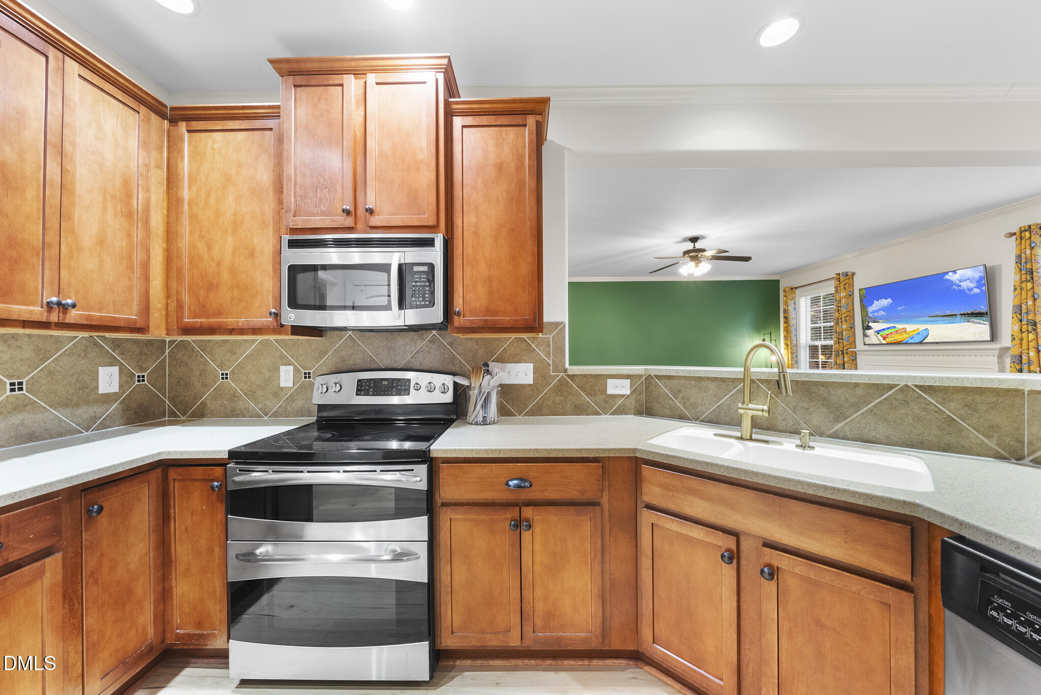 437 Big Willow Way Rolesville, NC 27571 - Photo 16 of 43 a kitchen with stainless steel appliances a sink stove and cabinets