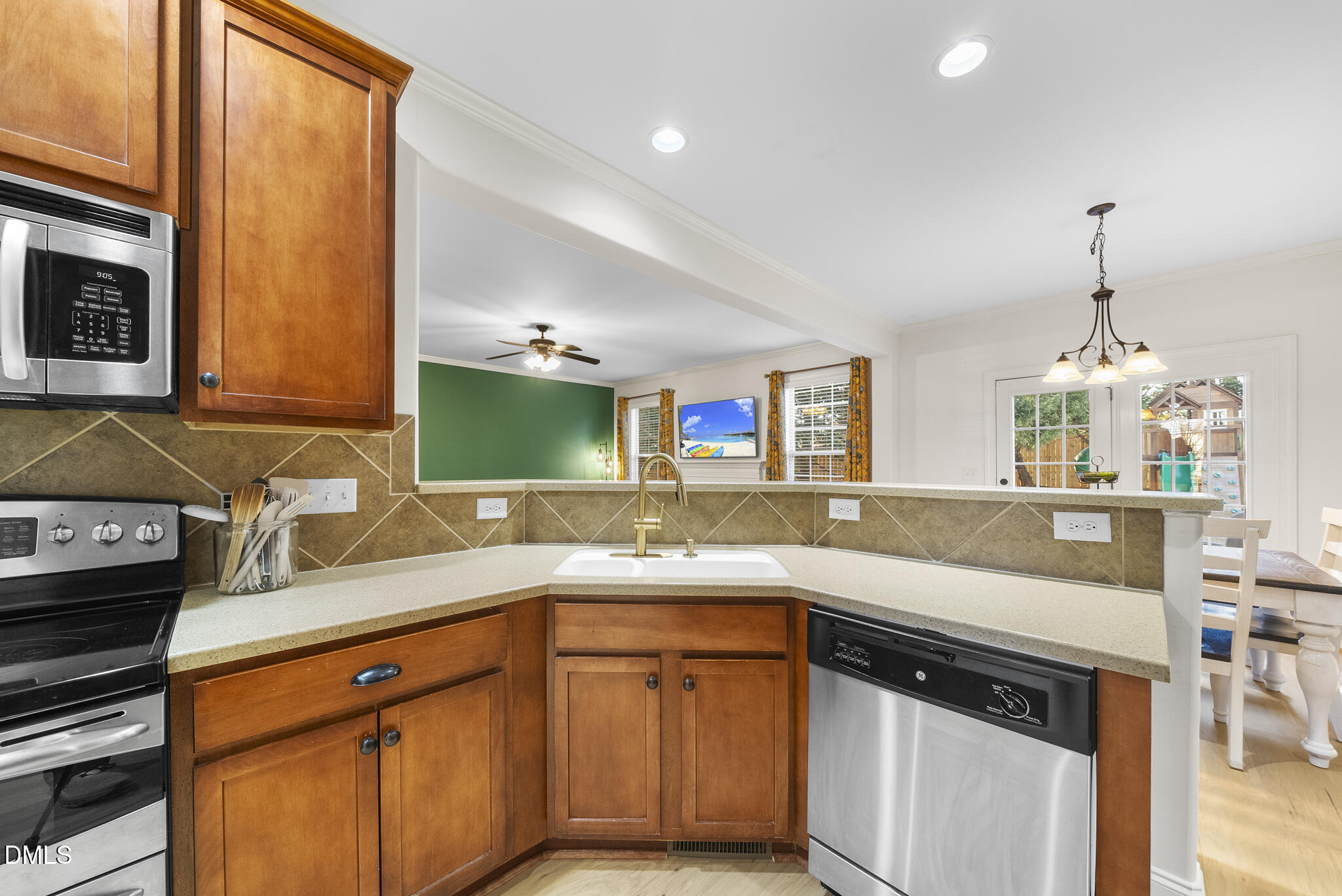 437 Big Willow Way Rolesville, NC 27571 - Photo 17 of 43 a kitchen with stainless steel appliances a sink stove and cabinets