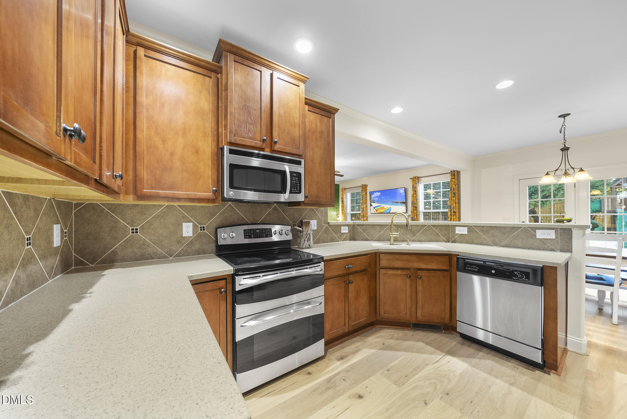 437 Big Willow Way Rolesville, NC 27571 - Photo 18 of 43 a kitchen with stainless steel appliances granite countertop a sink and stove top oven