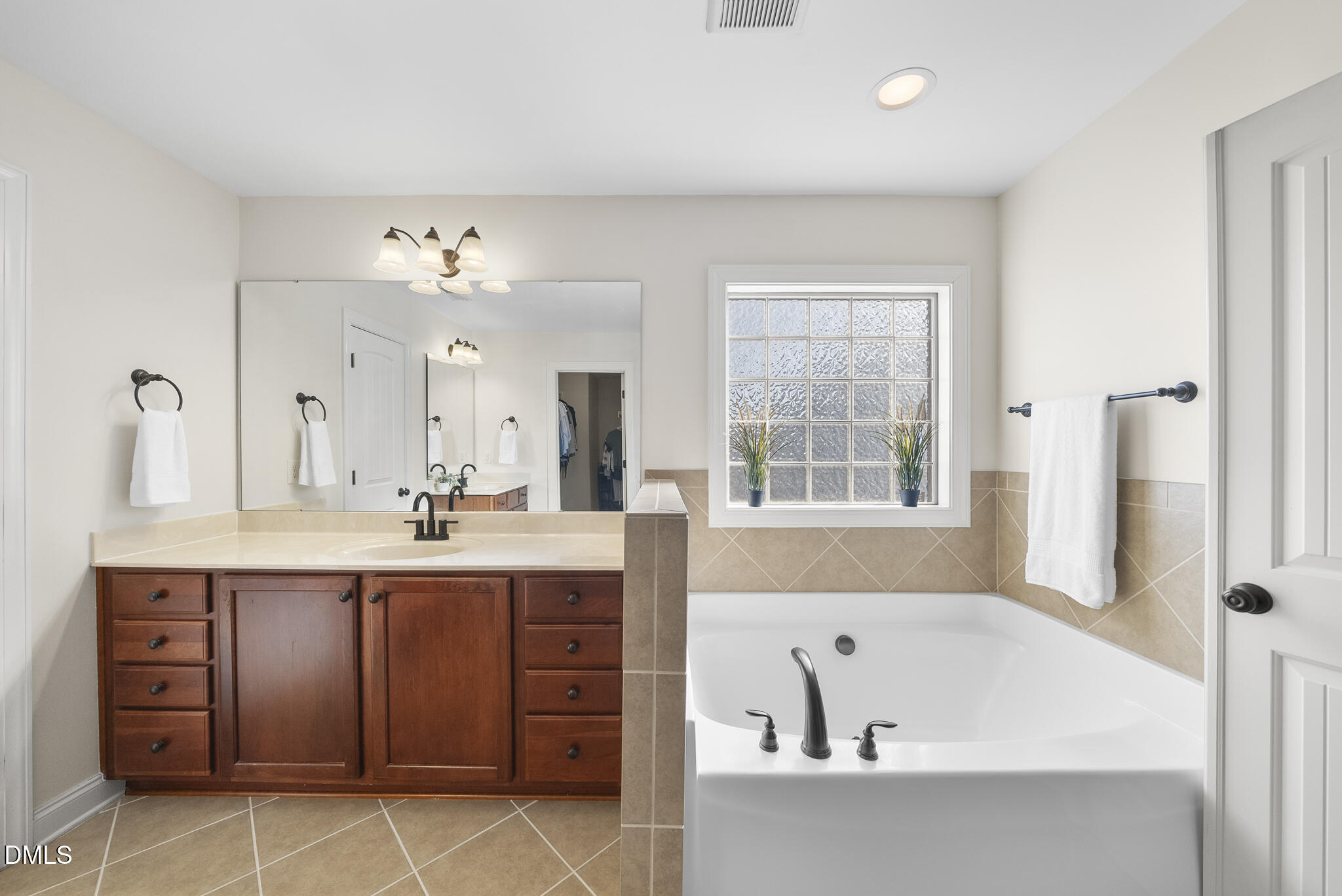 437 Big Willow Way Rolesville, NC 27571 - Photo 24 of 43 a bathroom with a tub sink and mirror
