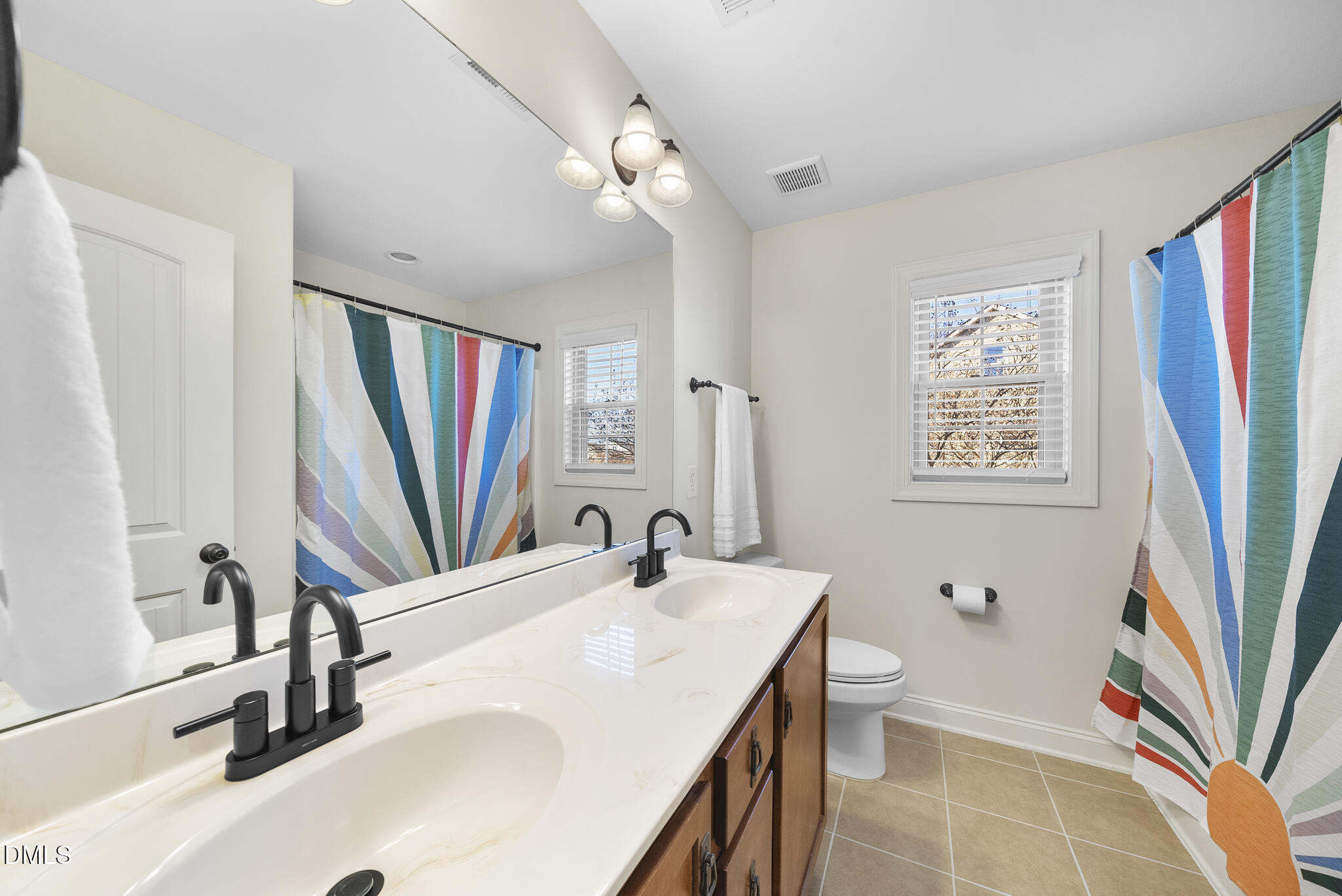 437 Big Willow Way Rolesville, NC 27571 - Photo 28 of 43 a bathroom with a sink a large mirror and a bathtub