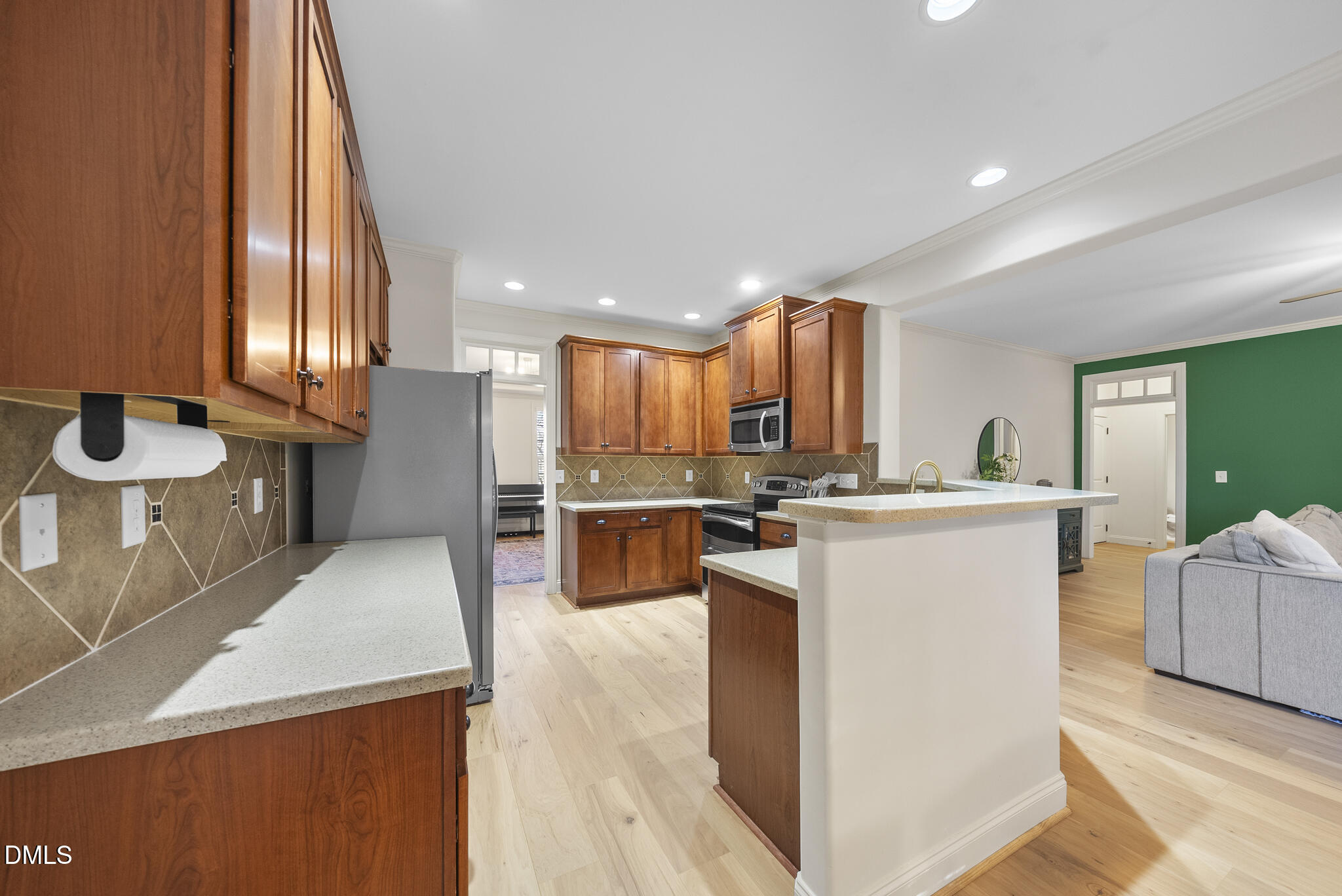 437 Big Willow Way Rolesville, NC 27571 - Photo 6 of 43 a view of kitchen with kitchen island stainless steel appliances a sink and living room view