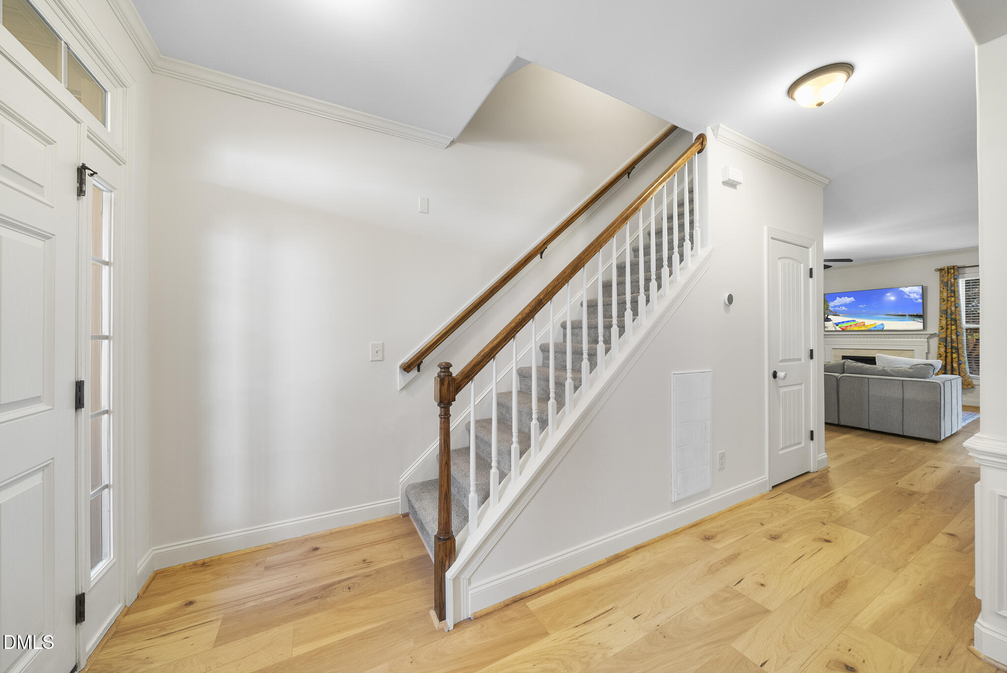 437 Big Willow Way Rolesville, NC 27571 - Photo 8 of 43 a view of a hallway with an entryway and wooden floor
