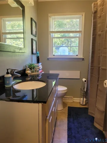 a dining room with a window and chairs