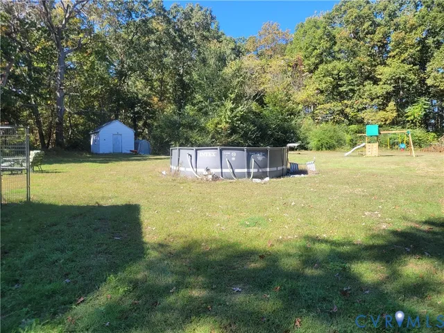 a swimming pool with some trees in the background
