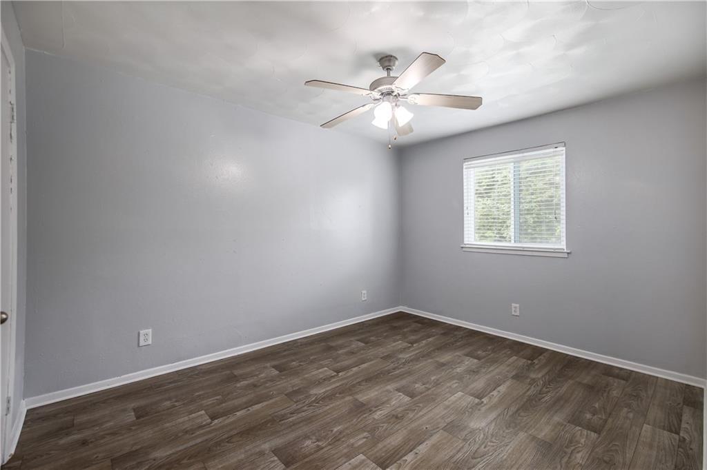 2401 Manor Road, Unit 102 Austin, TX 78722 - Photo 20 of 22 Spare room featuring dark wood-type flooring and ceiling fan