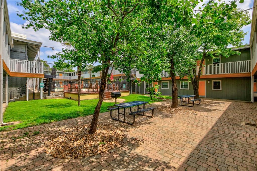 2401 Manor Road, Unit 102 Austin, TX 78722 - Photo 3 of 22 View of property's community with a patio area, a wooden deck, and a balcony