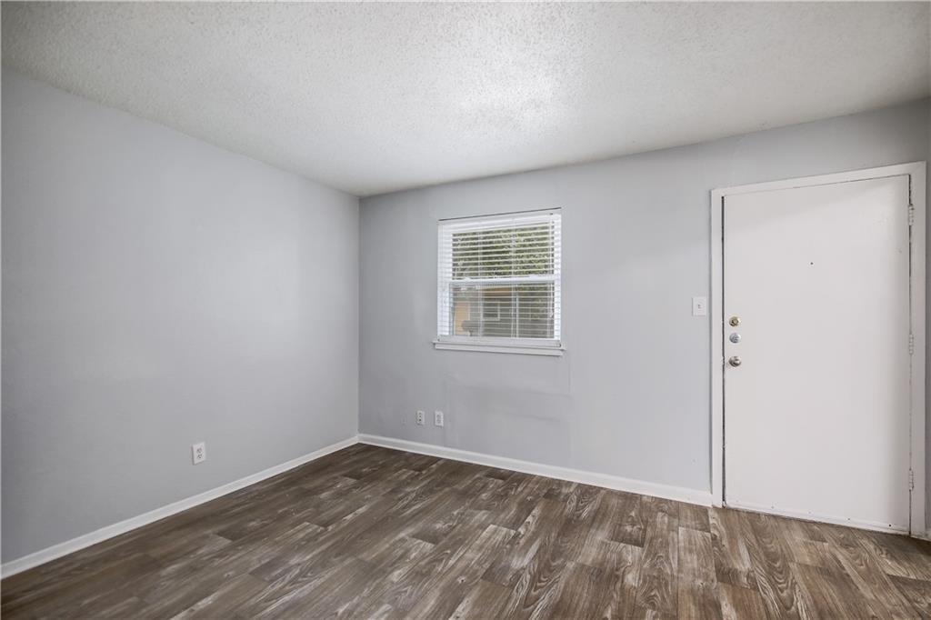 2401 Manor Road, Unit 102 Austin, TX 78722 - Photo 10 of 22 Entrance foyer featuring a textured ceiling and dark wood-style flooring