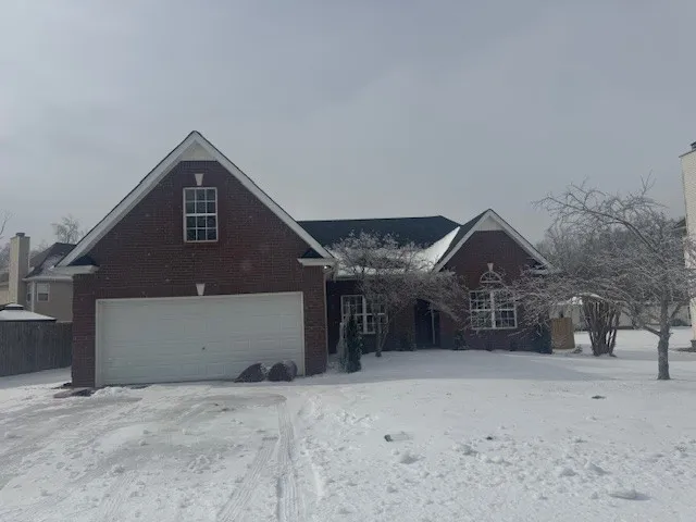 a view of a house with a snow in the yard
