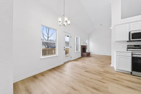 a view of a kitchen with a sink a refrigerator and window