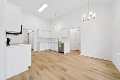 a view of a kitchen with wooden floor and a kitchen