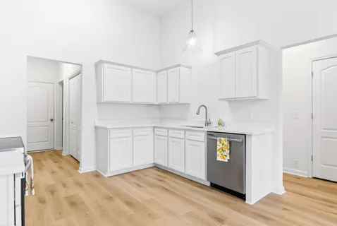 a kitchen with stainless steel appliances cabinets a sink and a stove