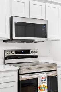 a stove top oven sitting inside of a kitchen