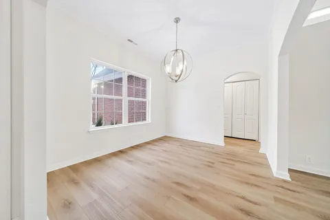 wooden floor in a hall with a window