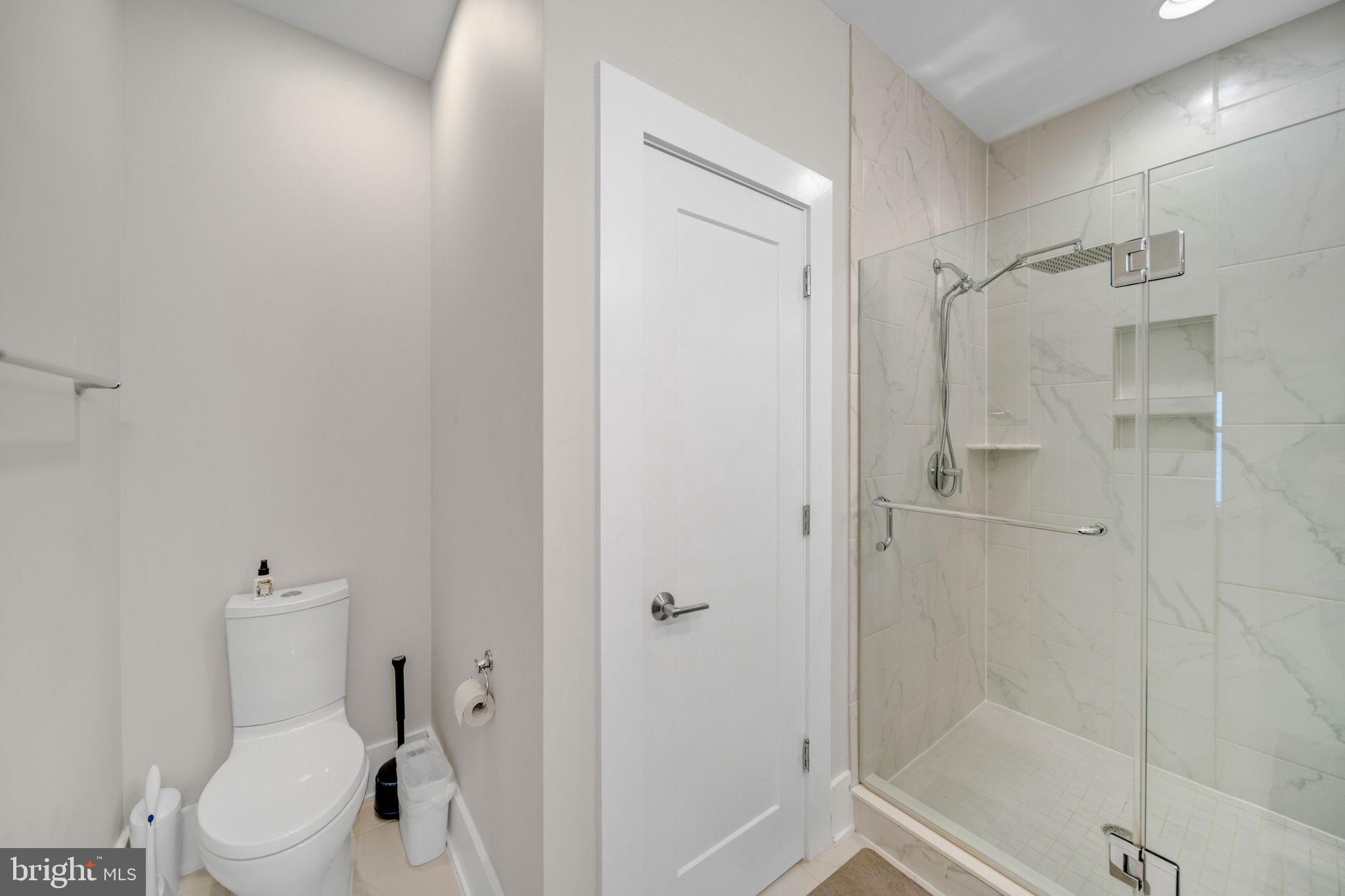 11326 Emerald Park Road Potomac, MD 20854 - Photo 14 of 40 Modern bathroom with sleek glass shower.