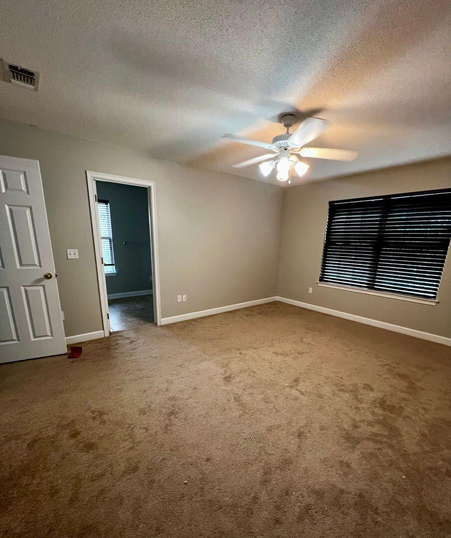 23 3rd Street Shalimar, FL 32579 - Photo 11 of 15 an empty room with chandelier fan and windows