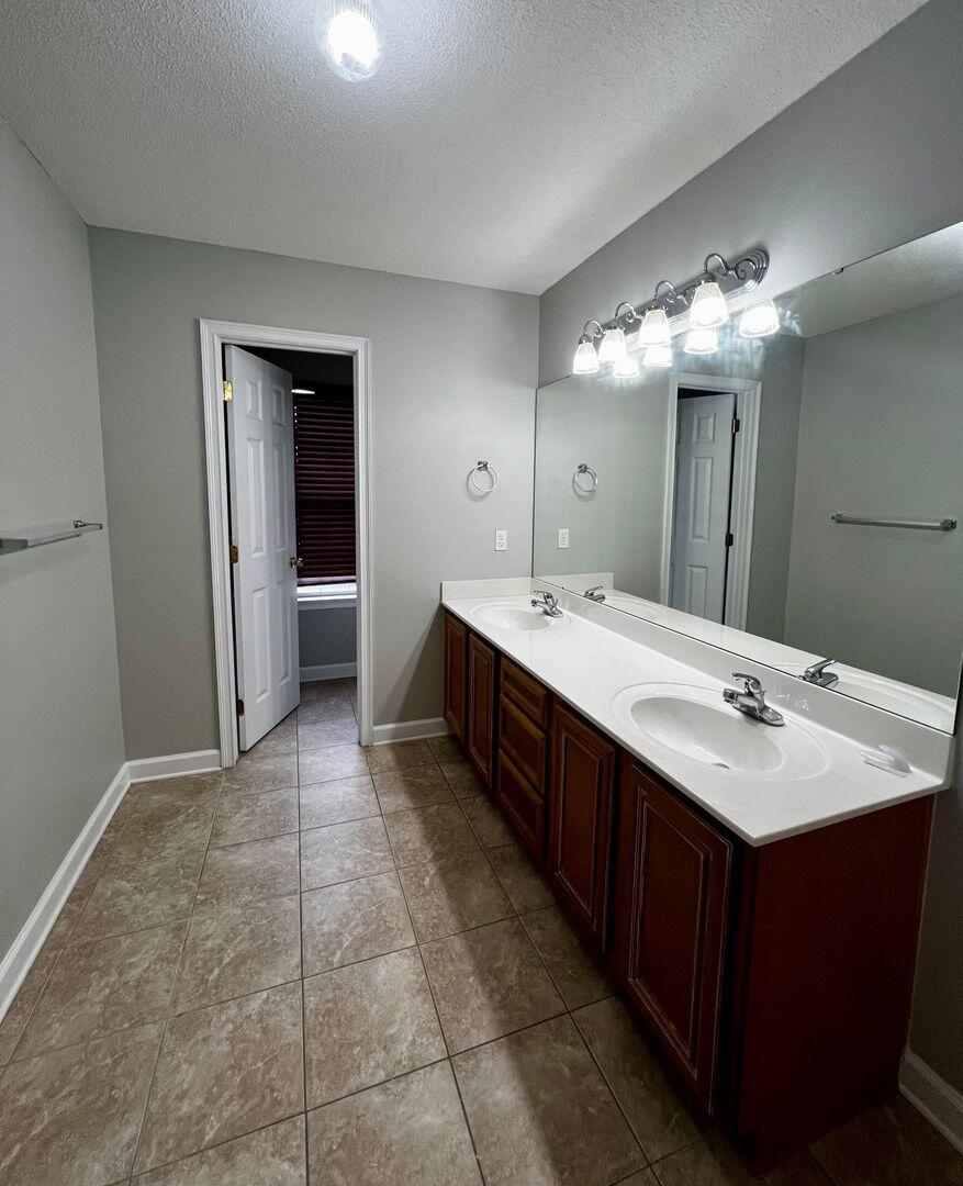 23 3rd Street Shalimar, FL 32579 - Photo 13 of 15 a bathroom with a double vanity sink and mirror