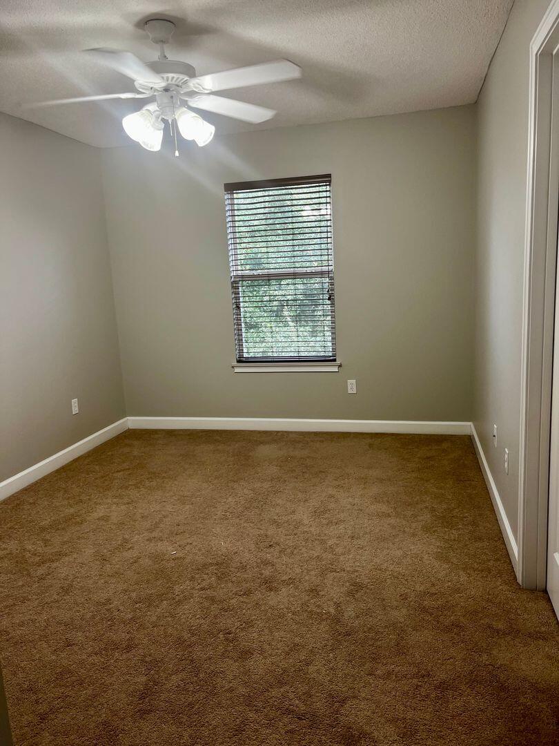 23 3rd Street Shalimar, FL 32579 - Photo 3 of 15 an empty room with a window and a fan