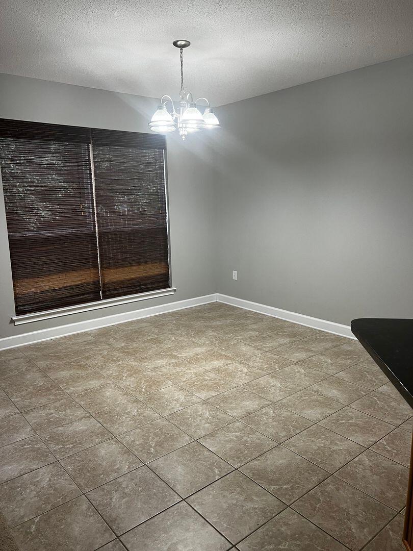 23 3rd Street Shalimar, FL 32579 - Photo 6 of 15 a view of an empty room with a fireplace