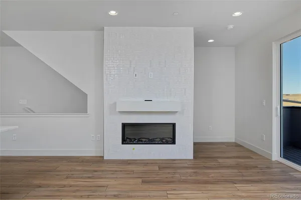 a kitchen with stainless steel appliances granite countertop white cabinets and a stove a refrigerator with white cabinets