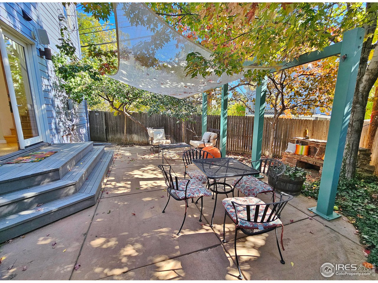 516 Valley View Drive Boulder, CO 80304 - Photo 32 of 35 Low Maintenance Backyard Oasis includes Red Rock Bench, Stained Concrete Patio, Decorative Metal Garden Arches, and Shade Sails