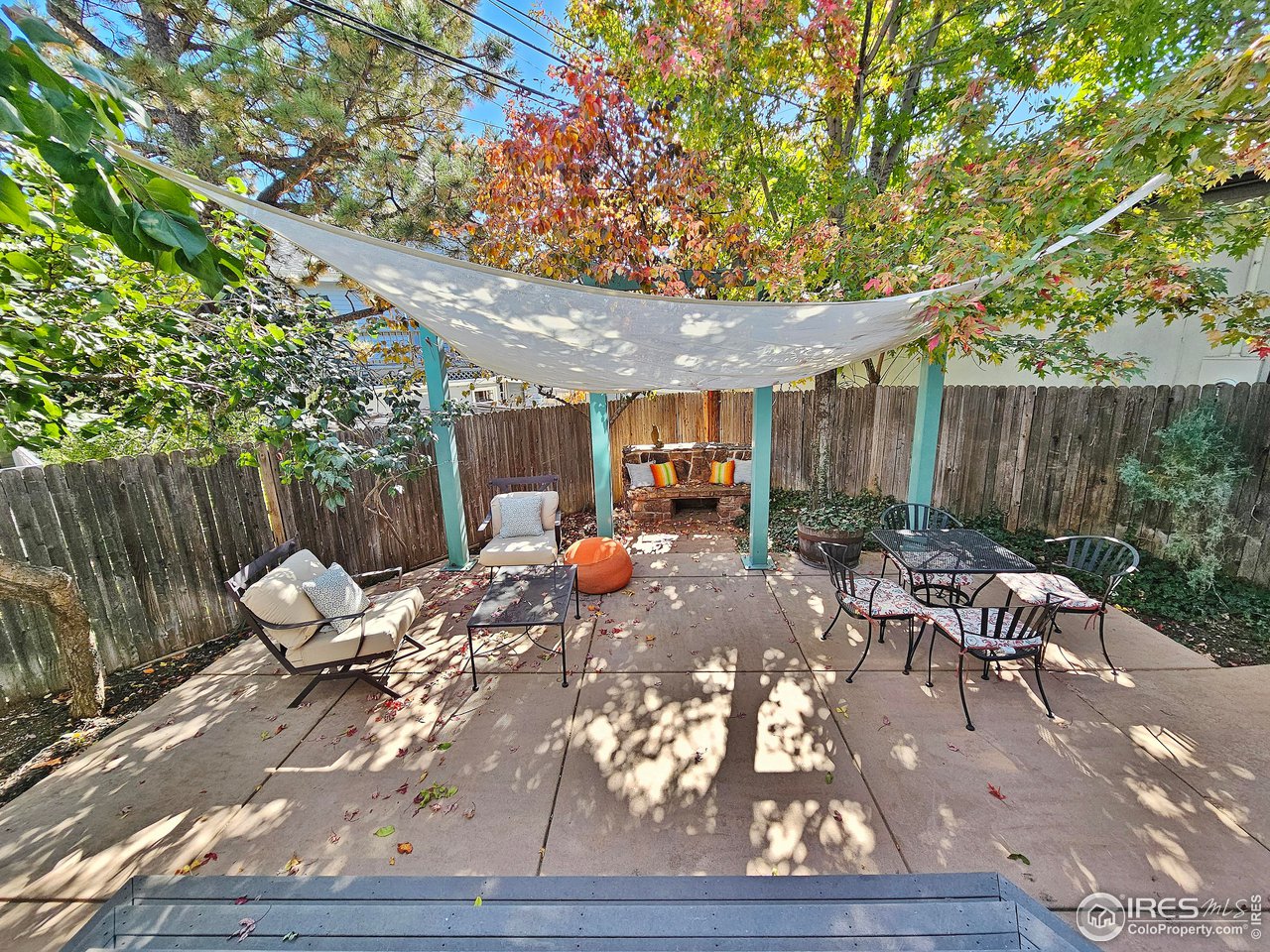 516 Valley View Drive Boulder, CO 80304 - Photo 33 of 35 Private Backyard Oasis includes Red Rock Bench, Stained Concrete Patio, Decorative Metal Garden Arches, and Shade Sails