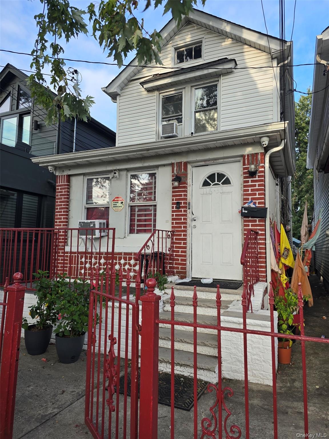 116-33 134th Street Queens, NY 11420 - Photo 1 of 13 View of front of home with brick siding, a fenced front yard, and a porch