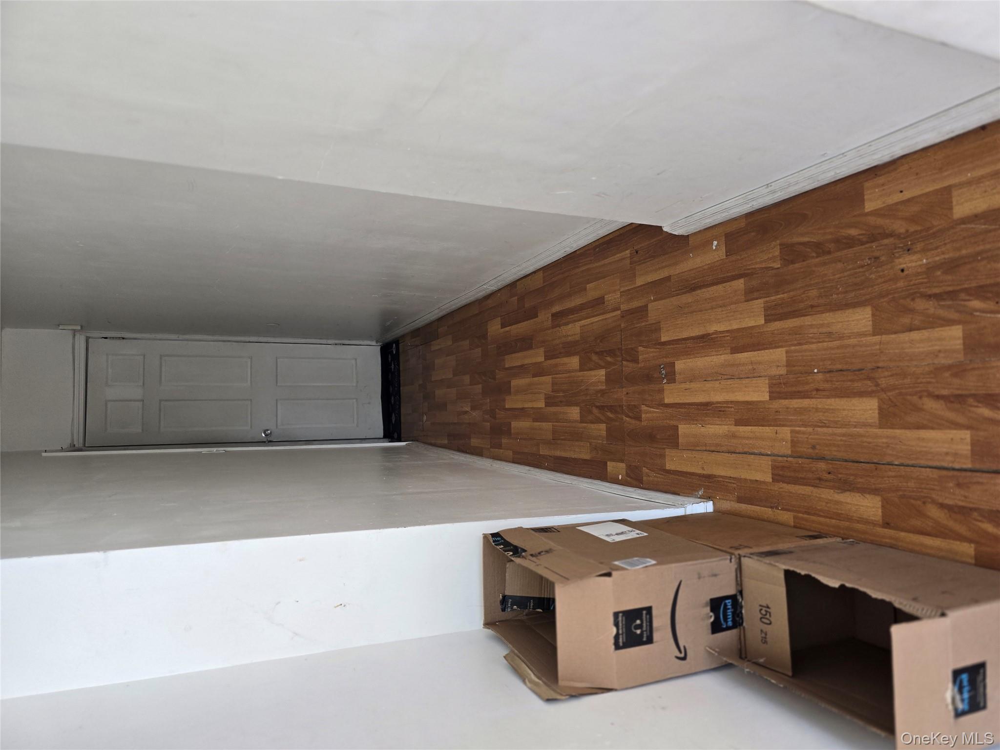 116-33 134th Street Queens, NY 11420 - Photo 8 of 13 Hallway with dark wood-style floors and baseboards