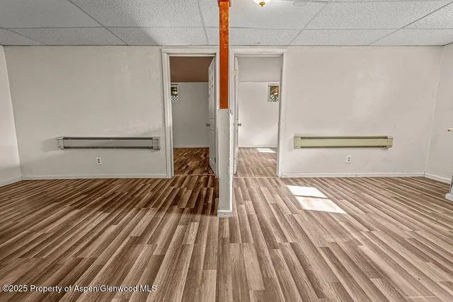 a view of a bedroom with wooden floor