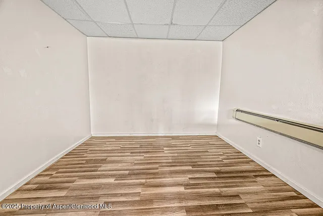 a view of a room with wooden floor