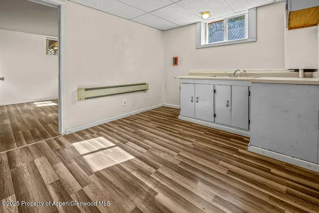 a view of a bedroom with wooden floor and cabinet