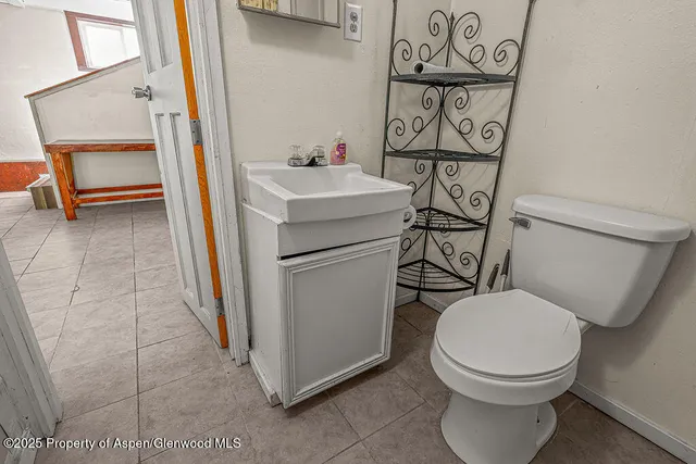a white toilet sitting next to a bathroom sink